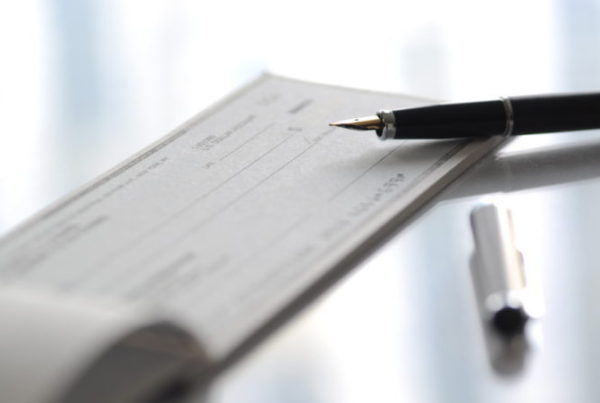 A financial adviser in Nottingham prepares to write a cheque