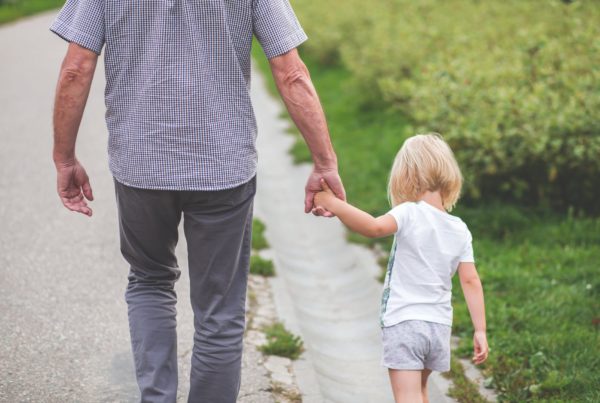 Nottingham IFA walks with a grand child through a garden